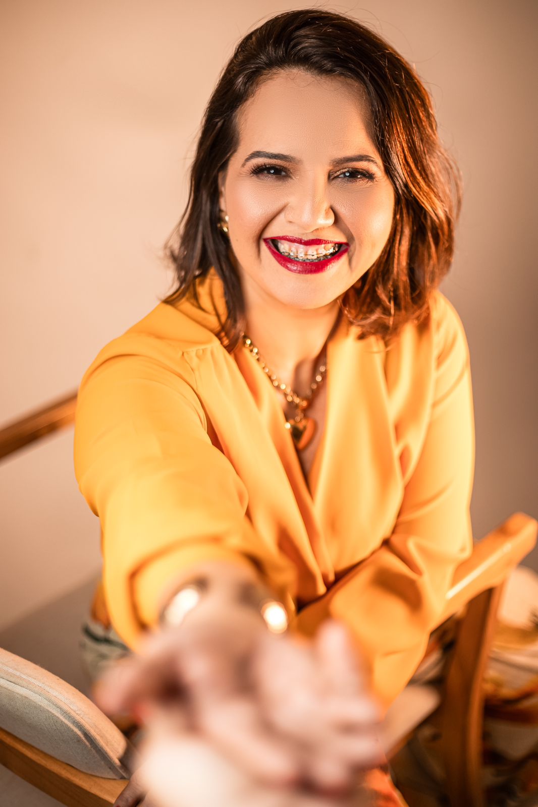 Terapeuta Pollyanna Pinheiro sorrindo em seu espaço de atendimento